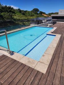 a swimming pool on a building with a wooden deck at Zimbali Lakes Boulevard Suites 157 in Ballito