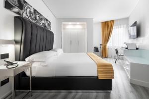 a bedroom with a large bed with a black headboard at LHP Napoli Palace & SPA in Naples +37 photos