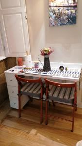 una mesa con un banco y un jarrón de flores en lita’s House Oporto Bainharia, en Oporto