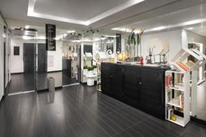 a large room with a black vanity and mirrors at LHP Napoli Palace & SPA in Naples