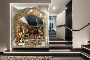 a large painting on a wall in a hallway with stairs at LHP Napoli Palace & SPA in Naples