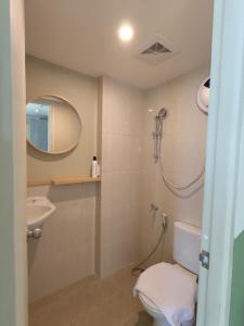 a bathroom with a shower and a toilet and a sink at Hotel Osaka PIK2 in Tangerang