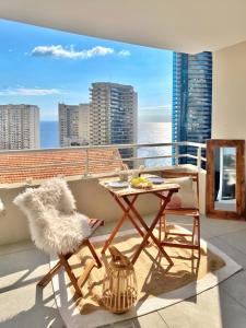 uma varanda com uma mesa e uma cadeira em Luxurious flat at 5 min by walk to Monaco, free parking and sea view em Beausoleil