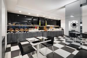 a restaurant with a black and white checkered floor at LHP Napoli Palace & SPA in Naples