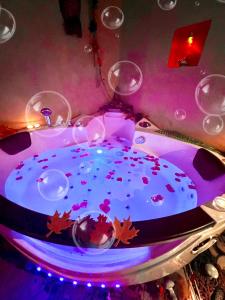 a purple table with a cake and wine glasses at Dormi nella SPA privata con letto ad acqua, sauna, doccia emozionale e kneipp in Alessandria +107 photos