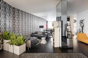 a living room with couches and plants at LHP Napoli Palace & SPA in Naples