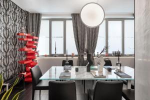 a dining room with a glass table and chairs at LHP Napoli Palace & SPA in Naples