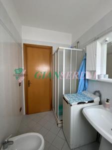 a bathroom with a sink and a toilet and a mirror at Campanile in San Vincenzo +7 photos