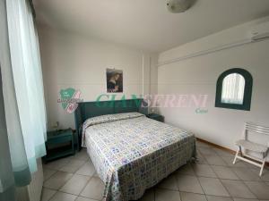 a bedroom with a bed and a chair in it at Campanile in San Vincenzo