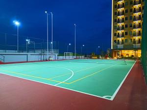 a tennis court in front of a building at night at Hotel Osaka PIK2 in Tangerang +34 photos