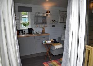 a kitchen with a sink and a table in a room at Riverview Lodges And Glamping in Welshpool