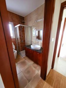 a bathroom with a sink and a toilet at Villa utopia in Paphos City