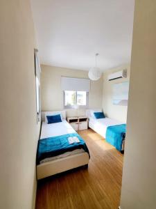 a room with two beds in a room at Villa utopia in Paphos City