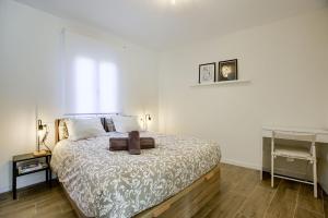 a bedroom with a bed and a desk in it at CASA MARMEL Plaza Castilla in Madrid