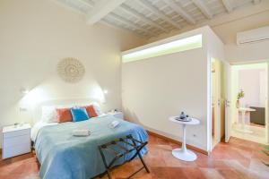 a bedroom with a bed with a blue blanket at Suite 109 in Rome