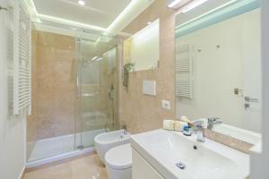 a bathroom with a toilet and a sink and a shower at Suite 109 in Rome +28 photos