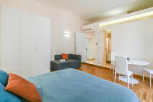 a bedroom with a bed and a couch and a table at Suite 109 in Rome