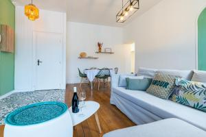 a living room with a couch and a table at Côté Cour - Centre Ville- Calme - Charme - 4 Voyageurs in Dijon