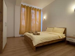 a bedroom with a bed with two bags on it at NEW Central nr2 Self Checkin OldCity Center Paid Parking with Lift in Timişoara