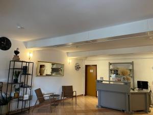 a living room with a table and chairs and a counter at Guest House Kolarin in Slano