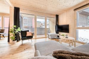 a living room with a couch and a tv at Ferienwohnung Family Plus zentral by A-Appartments in Brand