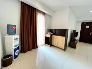 a living room with a television and a room with aperature at Lembah Permai Resort in Sindanglaya