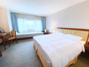 Gulta vai gultas numurā naktsmītnē Evergreen Laurel Hotel - Keelung