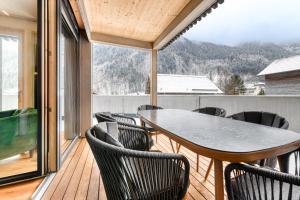 a patio with a table and chairs on a balcony at Familienferienwohnung Zentral by A-Appartments in Brand +28 photos
