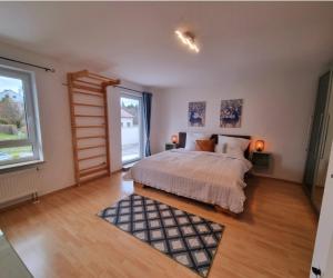 a bedroom with a bed and a large window at Ferienhaus im Luftkurort in Schömberg