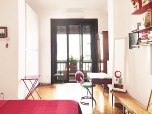 a living room with a person sitting at a desk at Art Design Duomo Suites in Milan