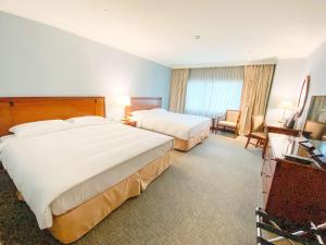 Gulta vai gultas numurā naktsmītnē Evergreen Laurel Hotel - Keelung