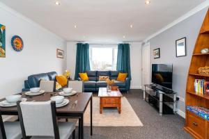 a living room with a couch and a table at Lovely 3-bedroom flat with free parking in Bridge of Allan