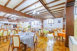 a large dining room with tables and chairs at Logis Hôtel de France in Arudy