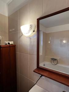 a bathroom with a large mirror and a sink at Rosenfeld 2 in Pinneberg +20 photos