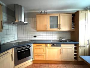 a kitchen with wooden cabinets and a sink at Rosenfeld 2 in Pinneberg +20 photos
