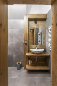 a bathroom with a sink and a mirror at Rent like home - Ubocz 1D in Zakopane