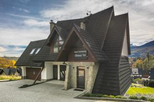 a house with a black roof on top of it at Rent like home - Ubocz 1D in Zakopane