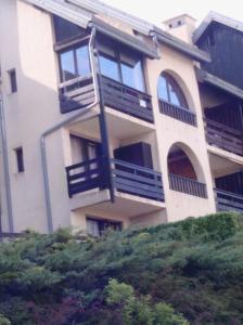 a building with balconies on the side of it at La Récré in Laye