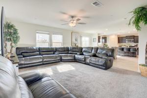 a living room with a black leather couch at Spacious Merced Vacation Rental! in Merced