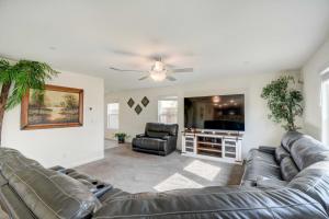 a living room with two leather couches and a tv at Spacious Merced Vacation Rental! in Merced