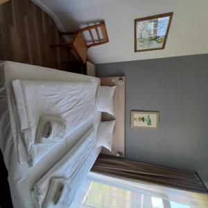 a bunk bed with white sheets and pillows on it at Die Remise Silbersee in Stolpe