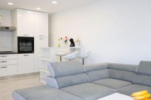 a living room with a couch and a kitchen at Apartments Ane 1 Tisno in Tisno