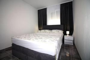 a bedroom with a large bed with a window at Apartments Ane 1 Tisno in Tisno
