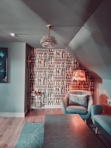 a living room with a wall of books at Weinbergs in Trelleborg