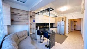 een woonkamer met een bank en een keuken bij Apartament de lux cu 2 camere și living in Chişinău