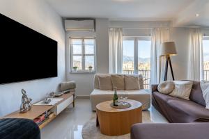 uma sala de estar com um sofá e uma televisão em Holiday Apartment Tres Coronas em Fuengirola