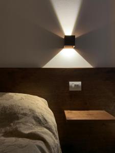 a bedroom with a bed and a light on the ceiling at Appartamento al castello di Arco in Arco