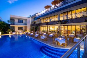 a hotel with a pool with tables and chairs at TOA Hotel & Spa Zanzibar in Pongwe