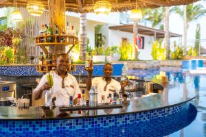two men sitting at a bar in a pool at TOA Hotel & Spa Zanzibar in Pongwe +37 photos