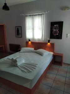 a large bed in a bedroom with a window at Amorgaia 2 in Katapola